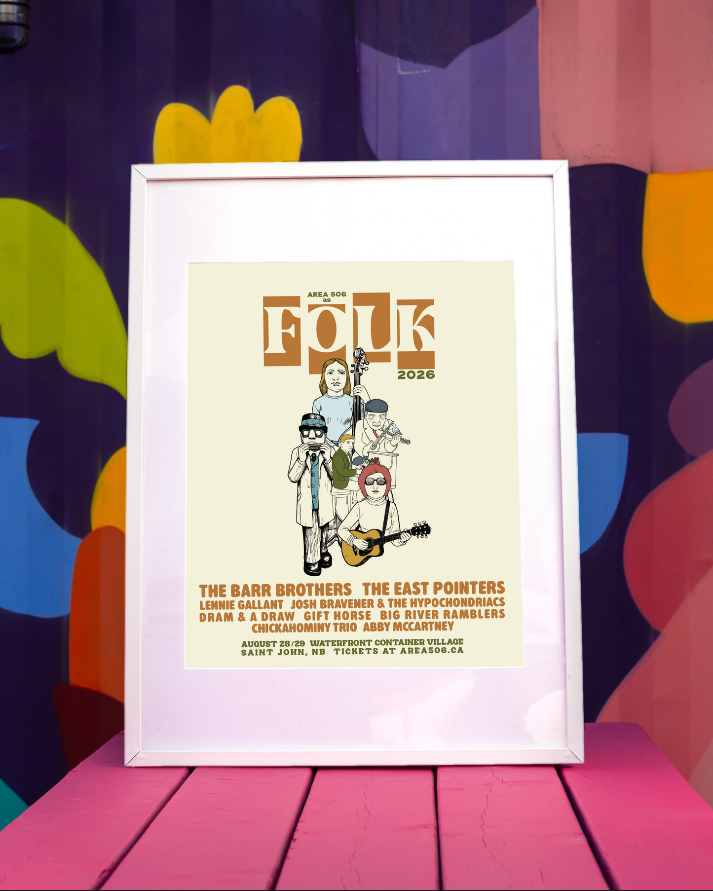 The AREA 506 as FOLK 2026 lineup poster, framed and sitting on a pink picnic table.