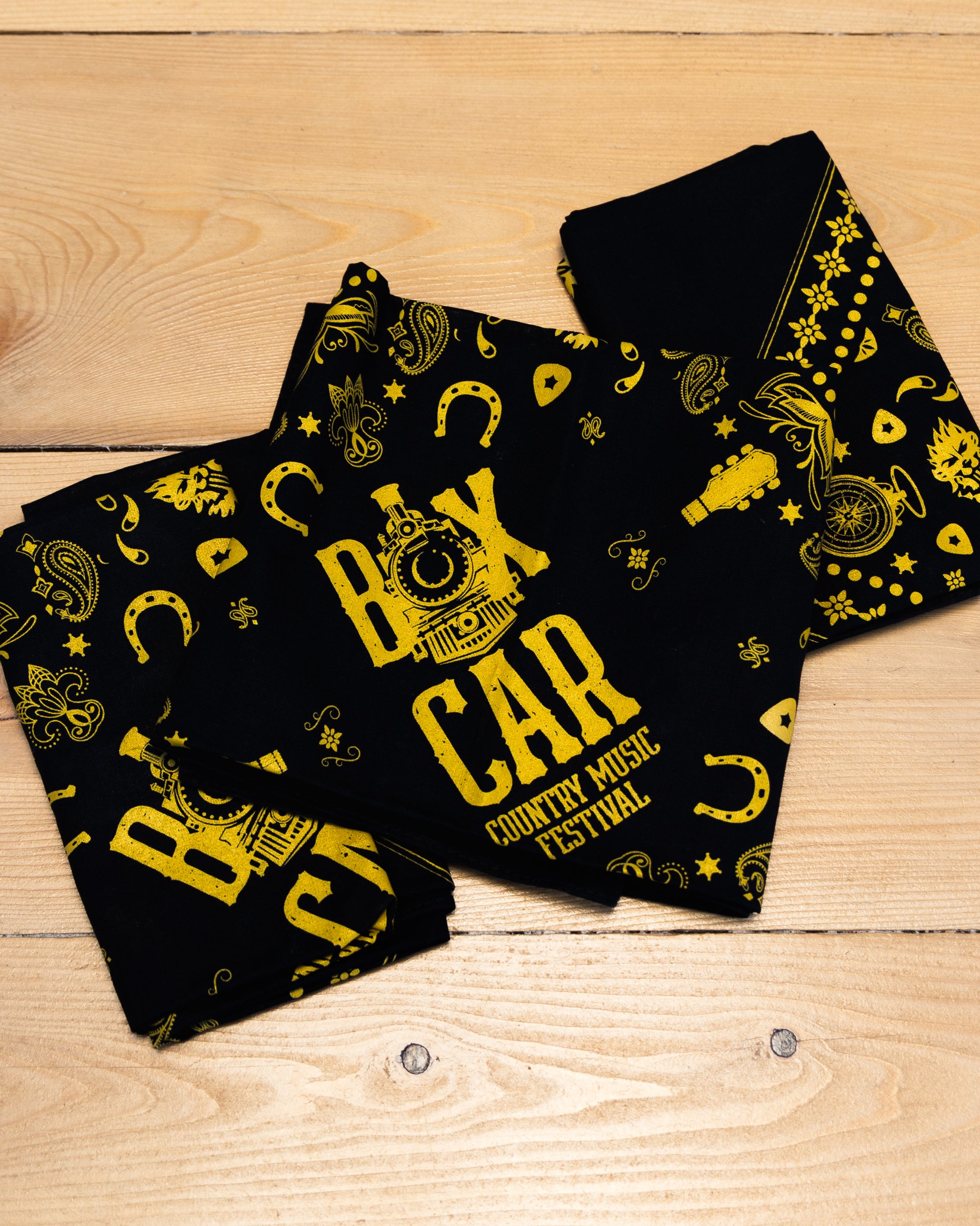 Black bandana with light brown imagery and Boxcar Country Music Festival text.