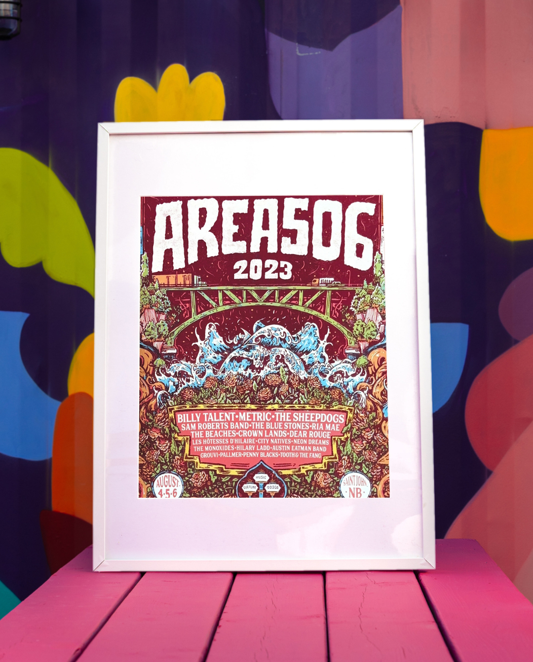 A collectible poster for the 2023 AREA 506 Music Festival, featuring a colourful design with the festival's logo and a list of performing artists.