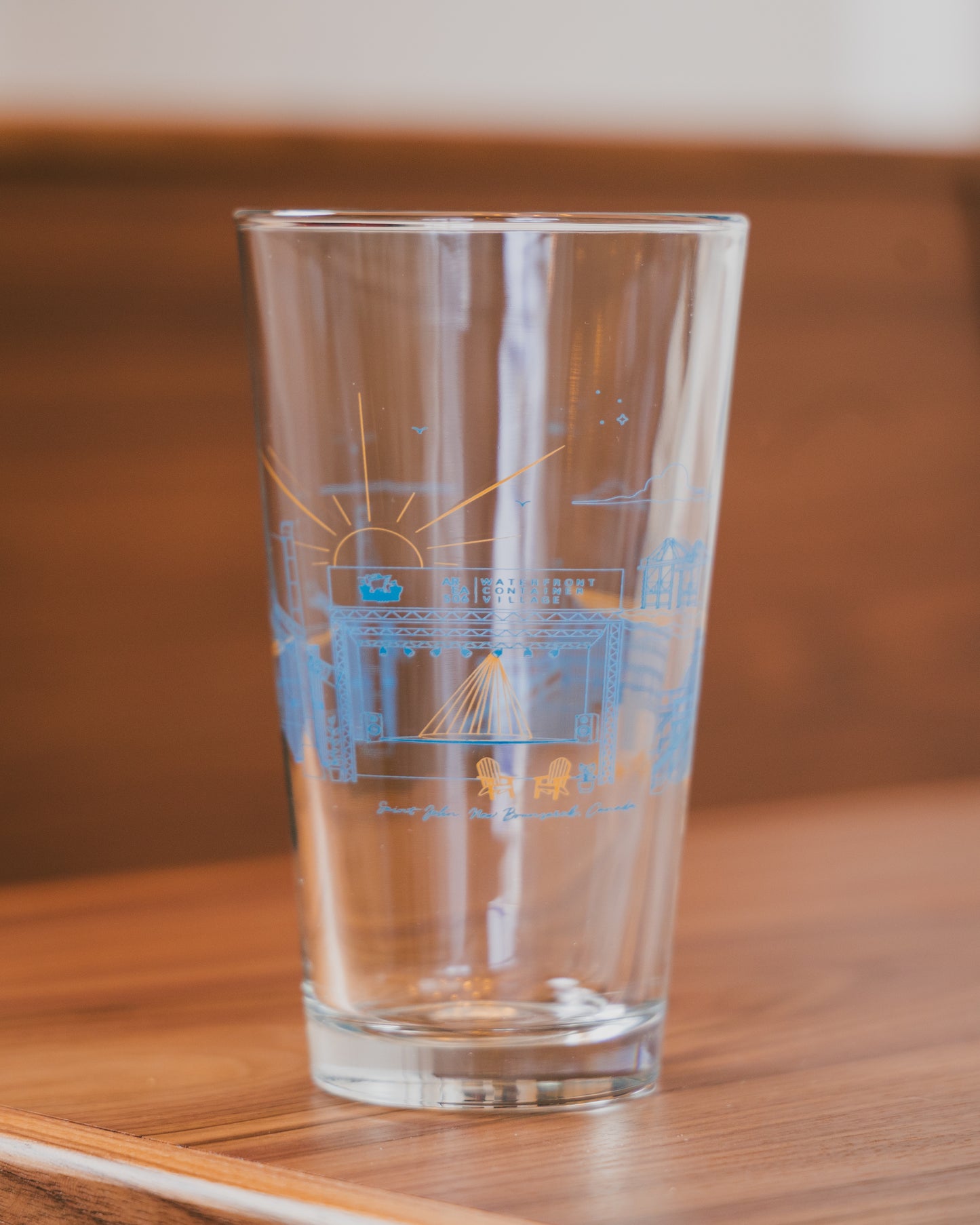Clear glass with blue etching on a wooden surface