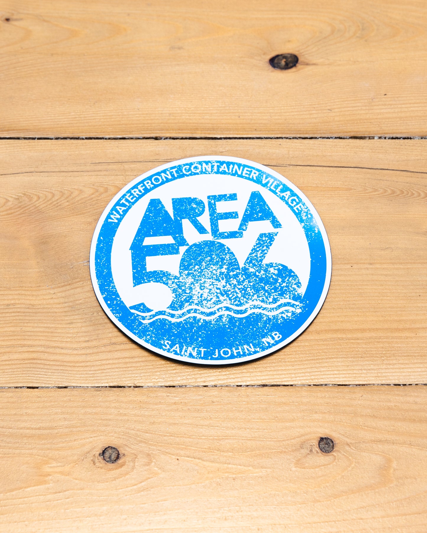 Round magnet with 'AREA 506' branding in blue.