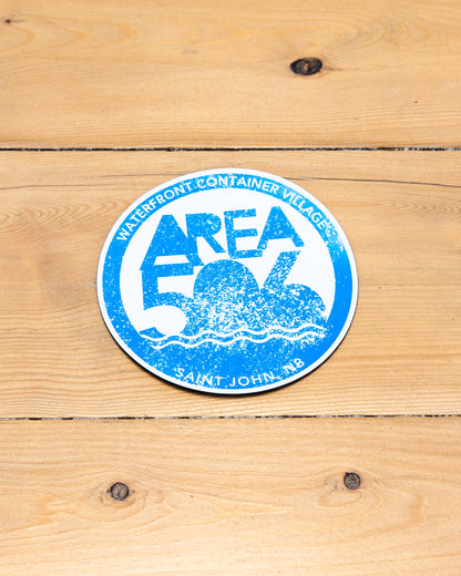 Round magnet with 'AREA 506' branding in blue.