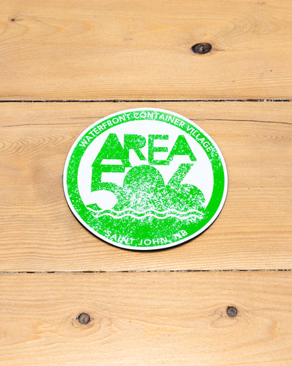 Round magnet with 'AREA 506' branding in green.